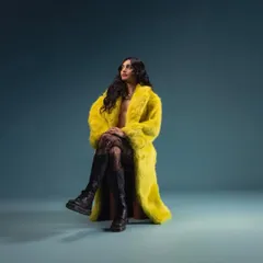 A full-length shot featuring my bright yellow fur coat. This piece is a statement, and I love incorporating bold fashion choices into my professional brand.
