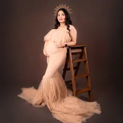 In this pose, I use a simple wooden ladder to add a rustic element and create a different angle for the portrait. The flowing tulle of the gown pools beautifully on the floor, adding texture and softness.