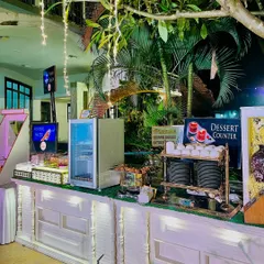 A dedicated dessert counter at an outdoor event. This setup ensures guests can easily access a variety of sweet treats while enjoying the party atmosphere.