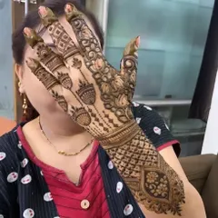 A fun pose showing off this intricate design with hanging pot-like motifs. The full-arm work is perfect for a big celebration.