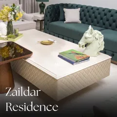 We believe a living room should be a statement of comfort. For the Zaildar Residence, we centered the design around this deep green velvet Chesterfield sofa, a timeless piece that exudes elegance. The entire space is a play on rich textures and a refreshing, nature-inspired color palette.
