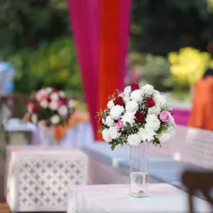 A simple yet elegant floral centerpiece in a clear vase, perfect for adding a touch of freshness to guest tables.