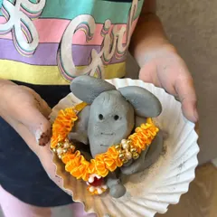 A close-up of a wonderfully detailed clay Ganesha, complete with a delicate garland. It's amazing to see what these tiny hands can create.