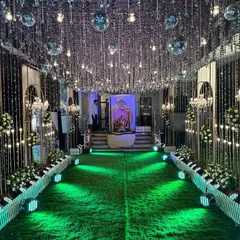 I designed this glamorous passage for a Sangeet night, with a ceiling covered in silver tassels and disco balls that reflect light everywhere. The walkway is lined with white floral arrangements and elegant chandeliers, creating a high-energy, celebratory entrance.