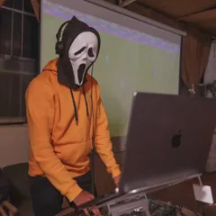 Even the DJ gets in on the fun. Rocking the Scream mask while spinning tracks for our Halloween party.