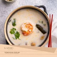A comforting bowl of Thai Tom Kha soup. This creamy coconut-based soup is infused with galangal and lemongrass, featuring a succulent prawn and fresh cilantro.