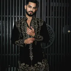 This black velvet kurta set is made for sophisticated celebrations. The exquisite gold handwork glistens with every movement, and the luxurious fabric drapes beautifully, ensuring you are the center of attention at any festive event.