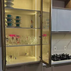 The doors of this crockery unit are open to show how much storage it offers. The glass shelves and internal lighting make it easy to find any cup or glass you need.