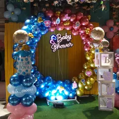 Here is another angle of the popular ring backdrop, showing how the lighting highlights the metallic balloons. I also add small details like baby-themed foil balloons and illuminated letter boxes to complete the look.