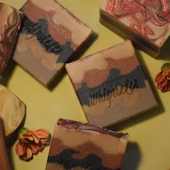 A flat lay of our Sandalwood soap bars, showing the intricate layers and natural, earthy tones. The scent is a divine blend of Sandalwood, Jasmine, and Vetiver.