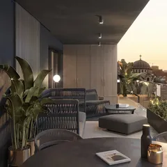 This balcony offers a timeless tropical retreat with a stunning city view. We used dark, woven furniture and large potted plants to create a sophisticated lounge atmosphere perfect for watching the sunset.