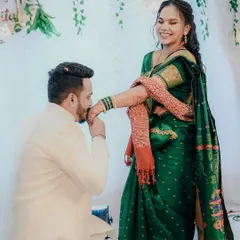 A chivalrous gesture as the groom kisses the bride's hand, her joyful reaction making this a perfect engagement memory.