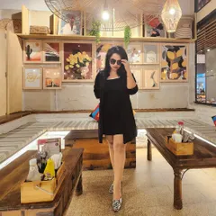 The same all-black outfit, demonstrating how to carry yourself with confidence in a social setting. Your presence should be consistent, from the boardroom to a cafe.