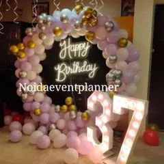 We provide light-up marquee numbers for any age or anniversary, shown here for a 37th birthday, paired with a pastel purple and silver balloon arch.