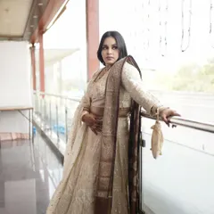 The sister of the bride, looking absolutely regal. For her look, we chose a smokey eye and a nude lip to complement her elegant ivory and brown lehenga.
