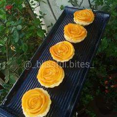 My elegant Mango Rose Tartlets, crafted to celebrate mango season. Each tartlet has a crisp biscuit base filled with cream and topped with fresh mango slices arranged in a beautiful rose pattern.