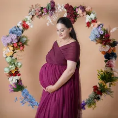 A moment of quiet reflection for the mother-to-be. Surrounded by a beautiful floral hoop, this portrait captures the serene and powerful glow of pregnancy in our Shimla studio.