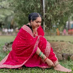 A graceful shot capturing the rich texture of the pink velvet Nauvari and the traditional green bangles. This shows the complete, authentic look I help create.