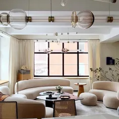 A large, multi-tiered installation of the Luna series in a contemporary living room. This demonstrates how the modular system can be expanded to fill a large volume with sculptural light.
