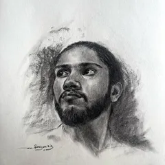 A charcoal portrait on paper. I enjoy the challenge of creating depth and realism with just black and white, focusing on the light in the subject's eyes and the texture of his beard.