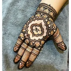 A personalized design for a guest, featuring their initials in a beautiful central motif. The surrounding floral pattern is intricate yet doesn't cover the entire hand, making it an elegant choice.