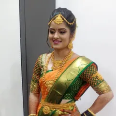 This bride is glowing in her orange silk saree. I used a warm, golden-toned makeup palette to complement her skin tone and the rich colors of her wedding attire, complete with a traditional waist belt.