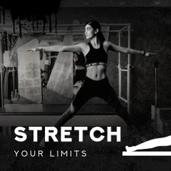 I am here to help you stretch your limits, both physically and mentally. This image captures the focus and determination we cultivate in our sessions, set against the backdrop of our professional studio.
