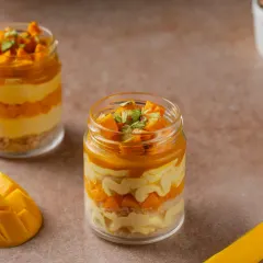 Dive into layers of creamy mango mousse, soft sponge, and juicy Alphonso mango chunks in our Mango Pistachio Jar Cake. It's a delicious and refreshing single-serving dessert.