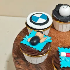 A closer look at the details on these themed cupcakes. This little swimmer is ready to dive into a chocolate frosting pool. Creating personalized fondant toppers like this is one of my favorite things to do.