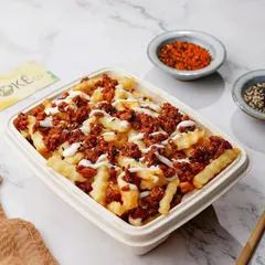 Loaded fries with mince and sauce in a delivery box, looking hearty and ready to eat.