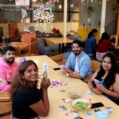 A group of friends enjoying a card game, all smiles and good vibes. Our space is perfect for a casual game night with your favorite people.