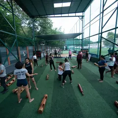 A wide view of a women-only session in progress. This image shows the scale of our community and the dynamic, active environment of our dugouts, with various stations and exercises happening simultaneously.