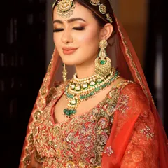 Eyes closed, the artistry shines through. This shot highlights the seamless eyeshadow blending and the soft, peachy tones that complement the bride's complexion.