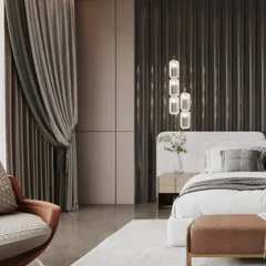 This bedroom design uses a dark, fluted panel feature wall behind the bed to create a dramatic and moody atmosphere. The deep tones of the wall contrast beautifully with the light-colored bed and soft rug.