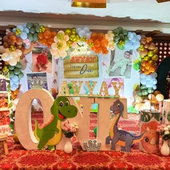 A roaring good time with this dinosaur-themed first birthday. We used cute dino cutouts, a custom 'ONE' table, and a milestone photo board to celebrate the big day.