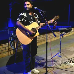 A candid shot from a live performance, just me and my guitar. I love connecting with the audience through my music in these settings.