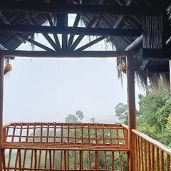 The view from the balcony of the mud house, looking out over the misty hills.