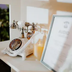 A close-up of the vintage rotary phone inside the audio guestbook booth, a charming detail that invites guests to "dial in" their wishes.