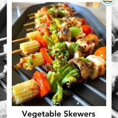Our colorful Vegetable Skewers are grilled to perfection, featuring zucchini, red onion, bell peppers, baby corn, and broccoli, drizzled with a tangy sauce.