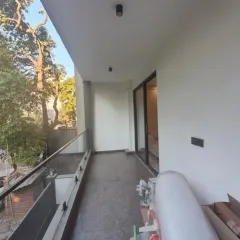 Another angle of the same incredible transformation. We started with a plain, empty balcony (7) and turned it into a luxurious retreat (8). Notice how the strategic lighting and mix of textures like wood, stone, and greenery create depth and warmth.