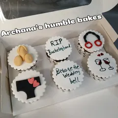 A set of cheeky cupcakes for a bachelorette party with fun messages and designs.