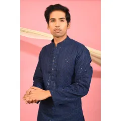 This portrait shot highlights the intricate chikankari and sequin detailing on the front of the navy blue kurta. It is a classic piece designed for understated elegance during the festive season.
