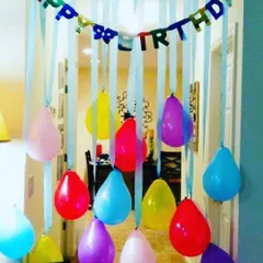 A classic and colorful doorway decoration. I use a 'Happy Birthday' banner and hanging balloons with ribbons to create a fun entrance for the guest of honor.