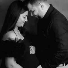 An intimate black and white close-up. This shot focuses on the couple's gentle embrace and the quiet moment they share, with soft lighting creating a romantic mood.