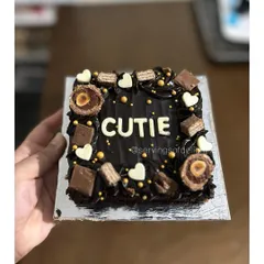 A mini brownie cake for a "Cutie"! This is my classic fudgy brownie, decorated with chocolate frosting, Ferrero Rocher, KitKats, and white chocolate hearts.