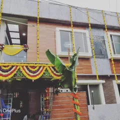 We decorate the entire home to reflect the joy of the occasion. This house exterior is adorned with hanging marigold flower strings and a traditional toran over the main balcony for a complete festive look.