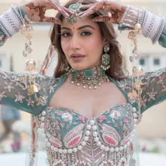 A close-up of the exquisite corset-style blouse, adorned with pearls and intricate floral embroidery. This is a perfect example of modern bridal couture.