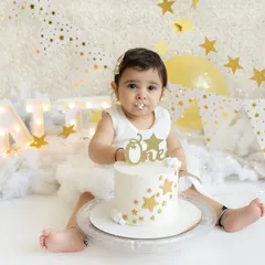 The first taste of cake! This little one is cautiously curious about her first birthday cake during our "Twinkle Star" themed cakesmash session.