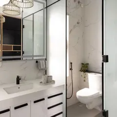 A duplicate of ID 63, this image shows the bright and modern bathroom vanity, complete with a quartz countertop, ample storage, and elegant crystal pendant lights.