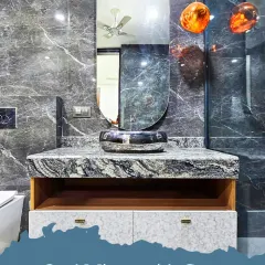 This vanity features a bold combination of grey and black marble, an oval mirror, and unique pendant lights, creating a dramatic and luxurious powder room.
